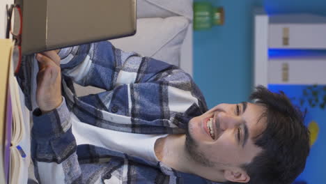Vertical-video-of-Happy-man-using-laptop-at-night.
